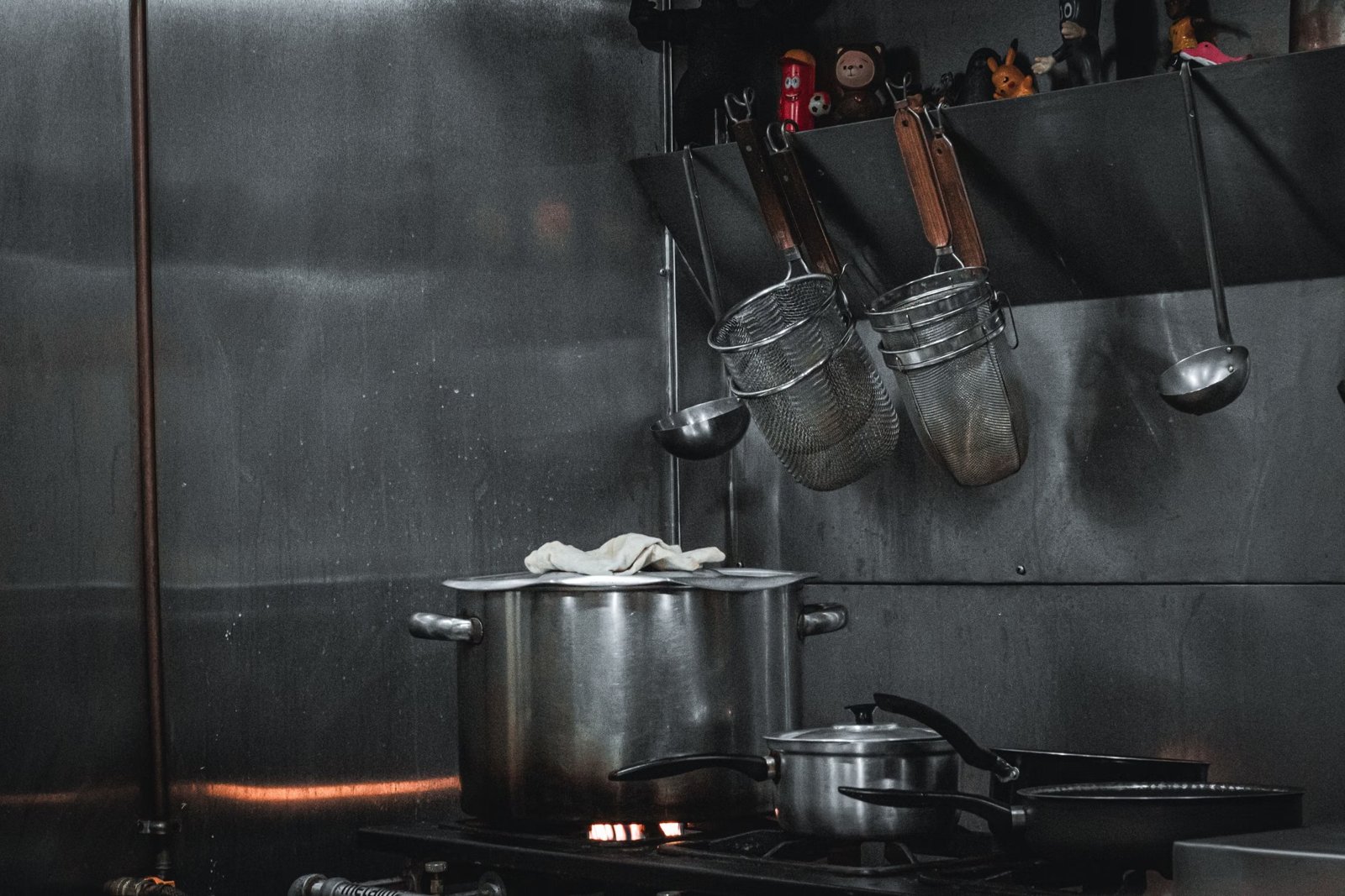 Pots and utensils in a stainless steel commercial kitchen
