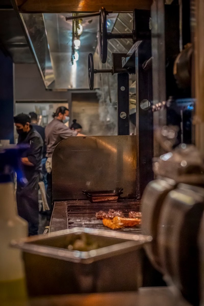 Chefs working at a commercial kitchen cooking line